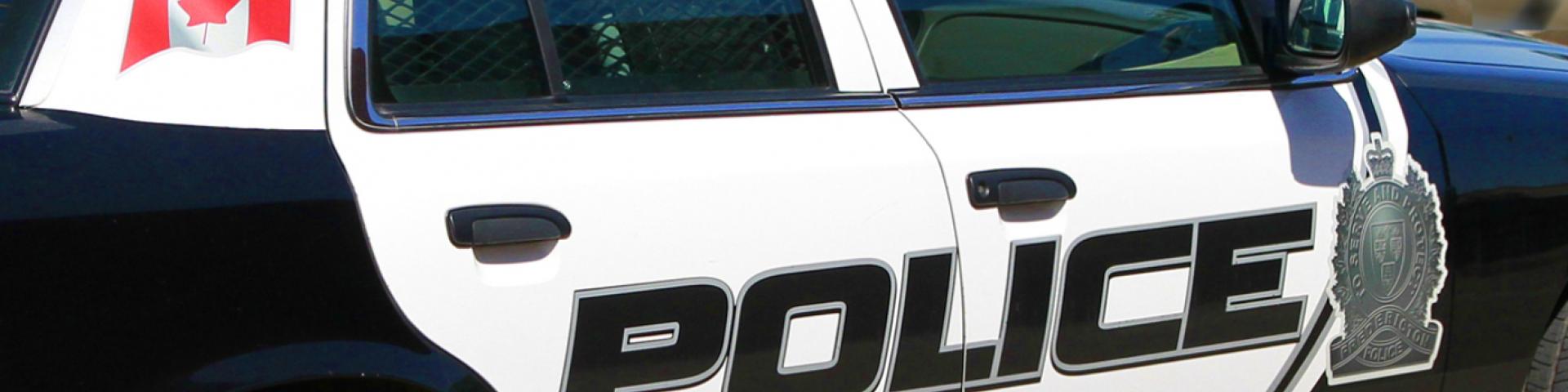 Side of a police car that reads out "Police."